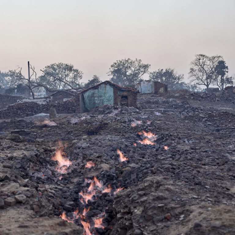 Photo of fires on blackened ground by Sebastian Sardi