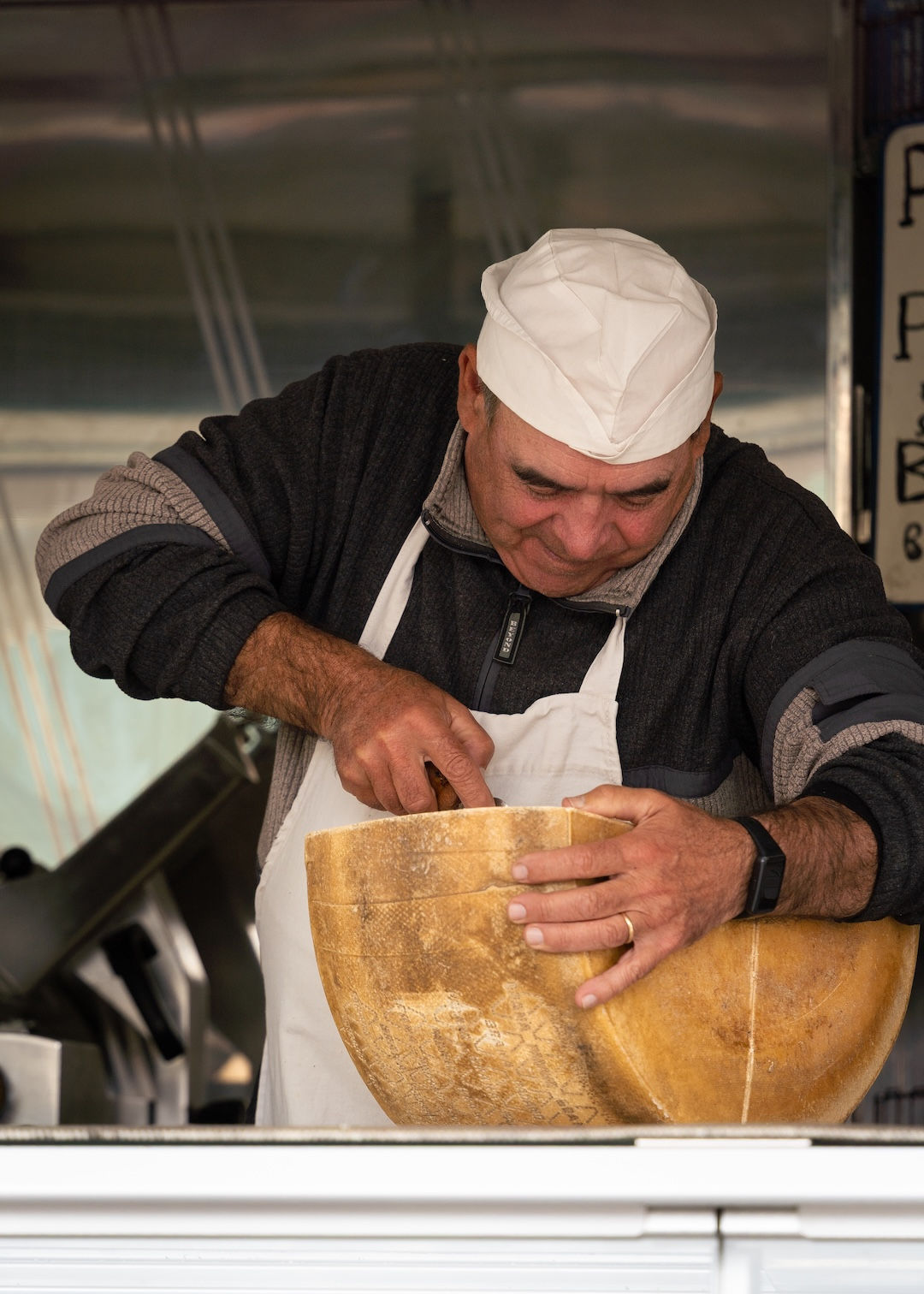 “Cheeseman” • Tuscany, Italy. A cheesemonger at his market stall cutting from a barrel of cheese • Shot with Tamron 28-200mm. ISO 125, 1/200 sec, f/5.6, 168mm.